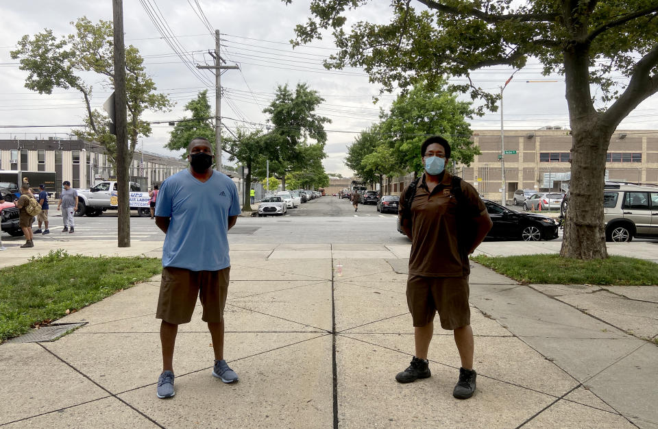 Dave Cockrel and Basil Darling, UPS drivers and union shop stewards, stand outside their UPS facility in Brooklyn, N.Y. UPS has seen booming business during the pandemic, but workers say long days and hundreds of deliveries have left them exhausted. (Lisa Riordan Seville / NBC News)