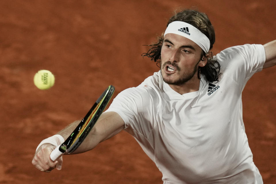 Stefanos Tsitsipas of Greece returns the ball to Russia's Daniil Medvedev during their quarterfinal match of the French Open tennis tournament at the Roland Garros stadium Tuesday, June 8, 2021 in Paris. (AP Photo/Thibault Camus)