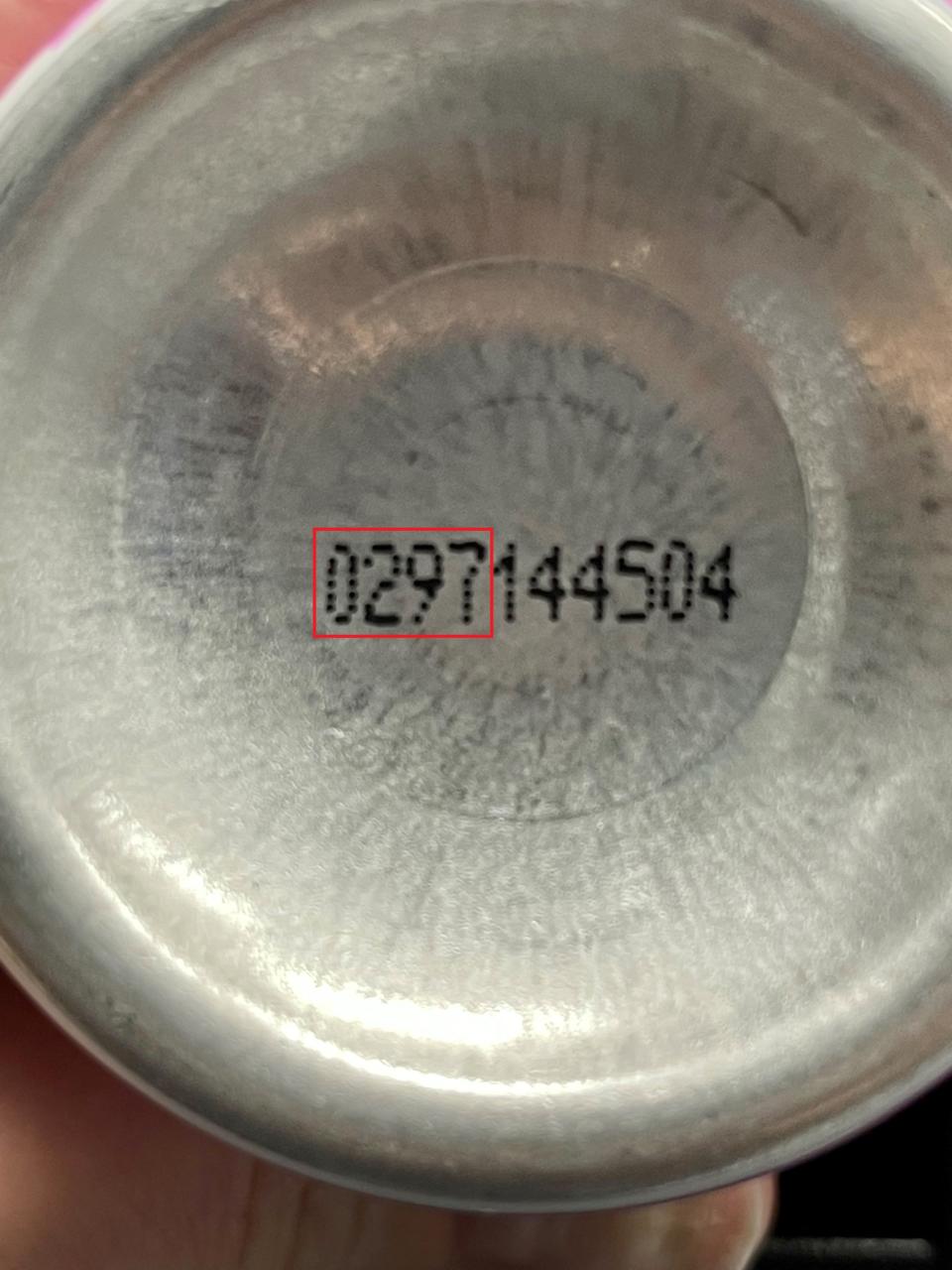 A production code shown at the bottom of an aerosol can.
