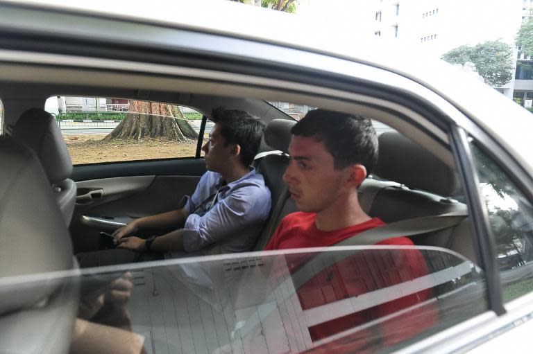 Andreas Von Knorre, (R) a German national arrested in Singapore for vandalism, arrives at court in a police car on November 22, 2014