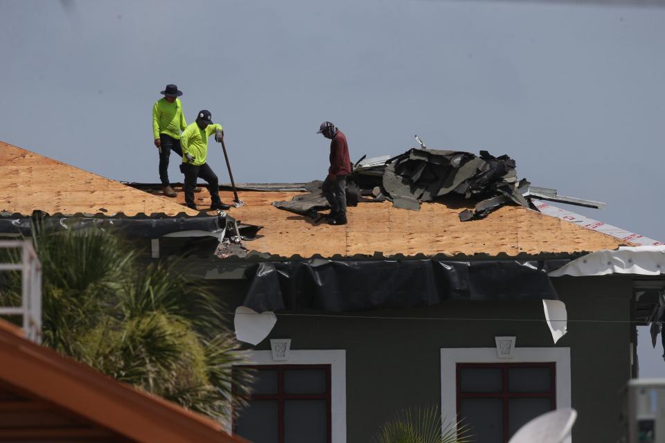 Roofers work in stifling hot conditions on Fort Myers Beach on Tuesday, July 11, 2023. Parts of Southwest Florida and South Florida are under a heat advisory through the next couple of days. 