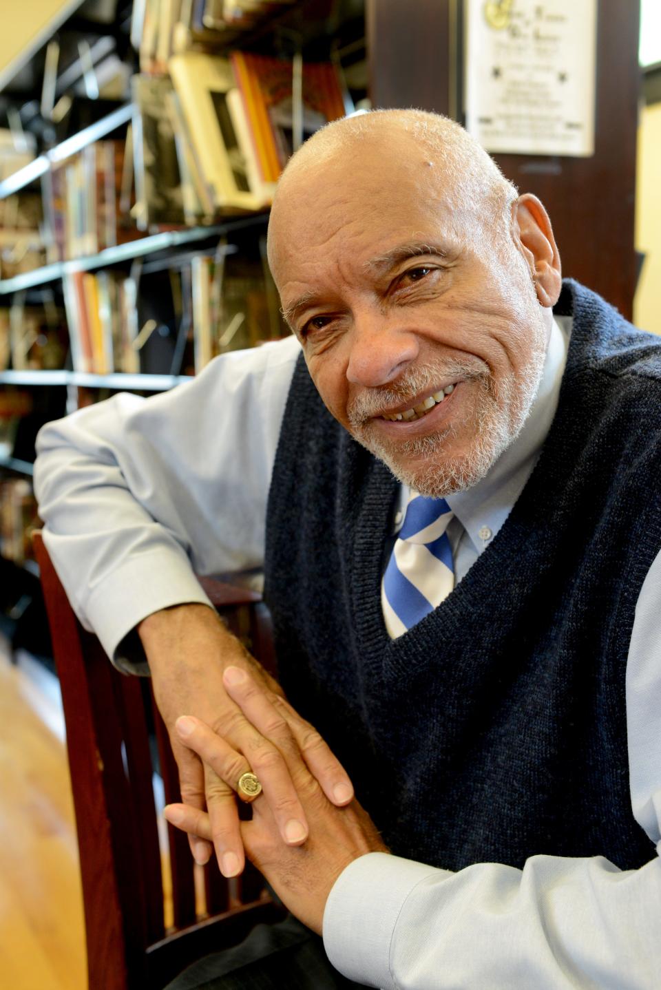 Bob Booker, sitting in the library at the Beck Cultural Exchange Center, talks about the locally famous photo of him peering out of a Knoxville city jail "peep slot" in 1961 after he was arrested for a civil rights protest at the Tennessee Theater.