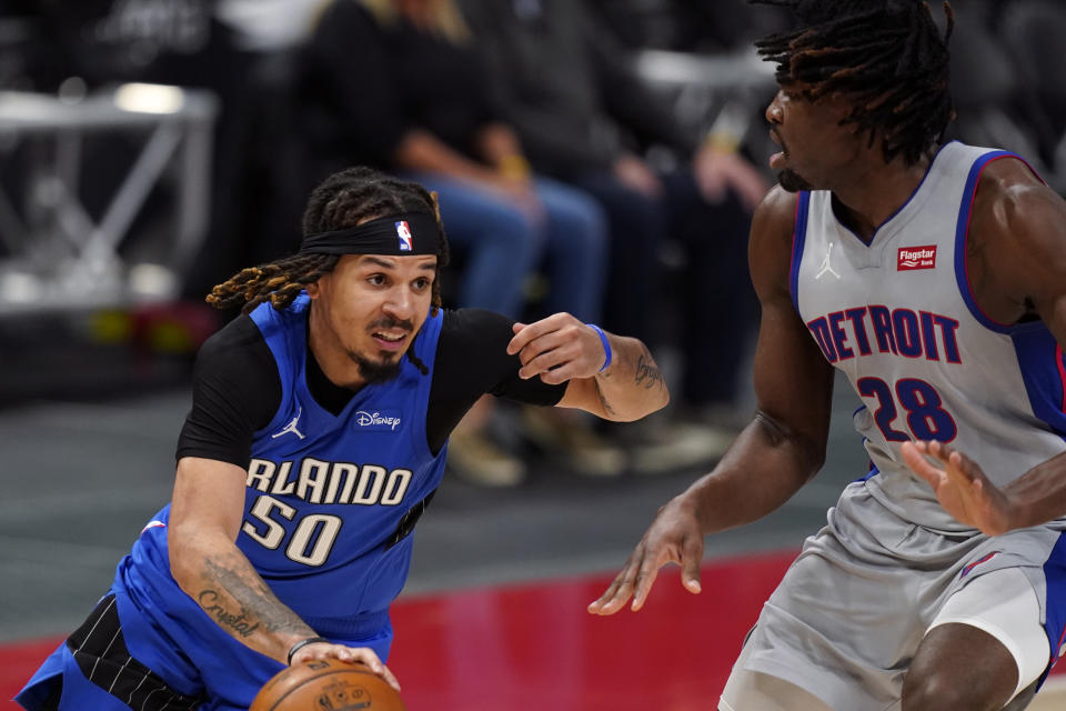 Orlando Magic guard Cole Anthony (50) drives as Detroit Pistons center Isaiah Stewart (28) defends during the second half of an NBA basketball game, Monday, May 3, 2021, in Detroit. (AP Photo/Carlos Osorio)