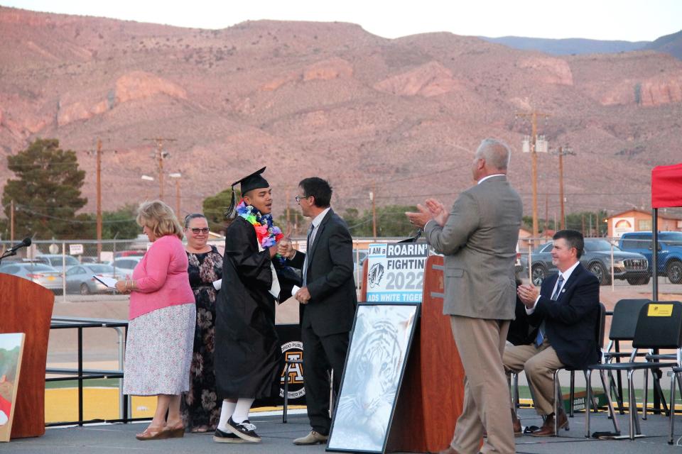 A student and Academy del Sol Principal Roman Renteria share a fist bump  at Academy del Sol's graduation ceremony May 26, 2022.

Alamogordo Public Schools alternative high school Academy del Sol celebrated its final commencement ceremony on May 26, 2022.