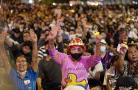 Anti-government protesters flash the three finger protest gesture during a rally Wednesday, Dec. 2, 2020 in Bangkok, Thailand. Thailand's highest court Wednesday acquitted Prime Minister Prayuth Chan-ocha of breaching ethics clauses in the country's constitution, allowing him to stay in his job. (AP Photo/Gemunu Amarasinghe)