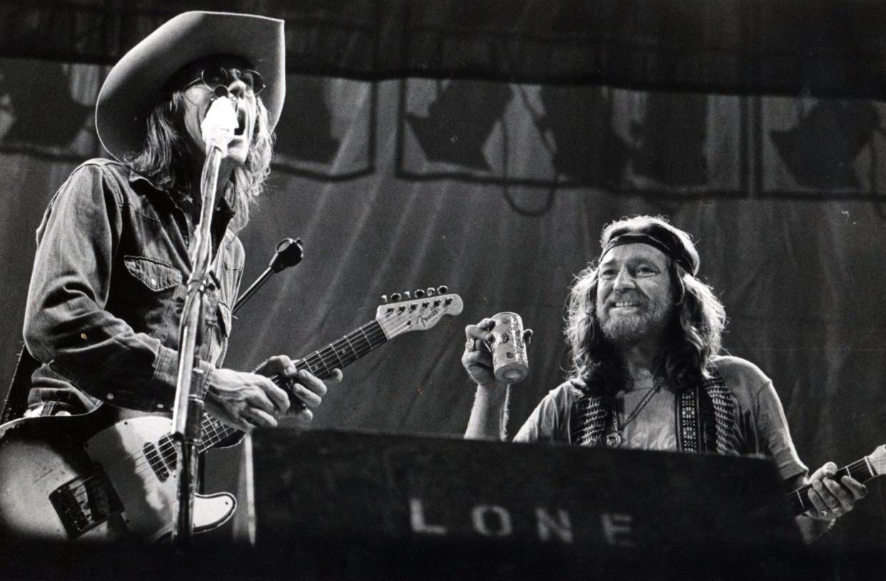 1976: One of our most famous photos from the Willie Nelson Fourth of July Picnic outside Gonzales. Willie joins Doug Sahm onstage during Sahm’s set.