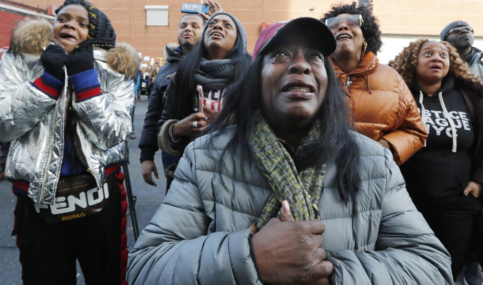 Catana Yehudah, foreground, of the Bronx, cries as she hears the response of prisoners held inside the Metropolitan Detention Center, a federal facility with all security levels, Sunday, Feb. 3, 2019, in the Brooklyn borough of New York. The prison has been without heat, hot water, electricity and good sanitation for several days, including during the recent frigid weather. Yehudah has a brother who is serving 18 months at the prison for gun possession. (AP Photo/Kathy Willens)