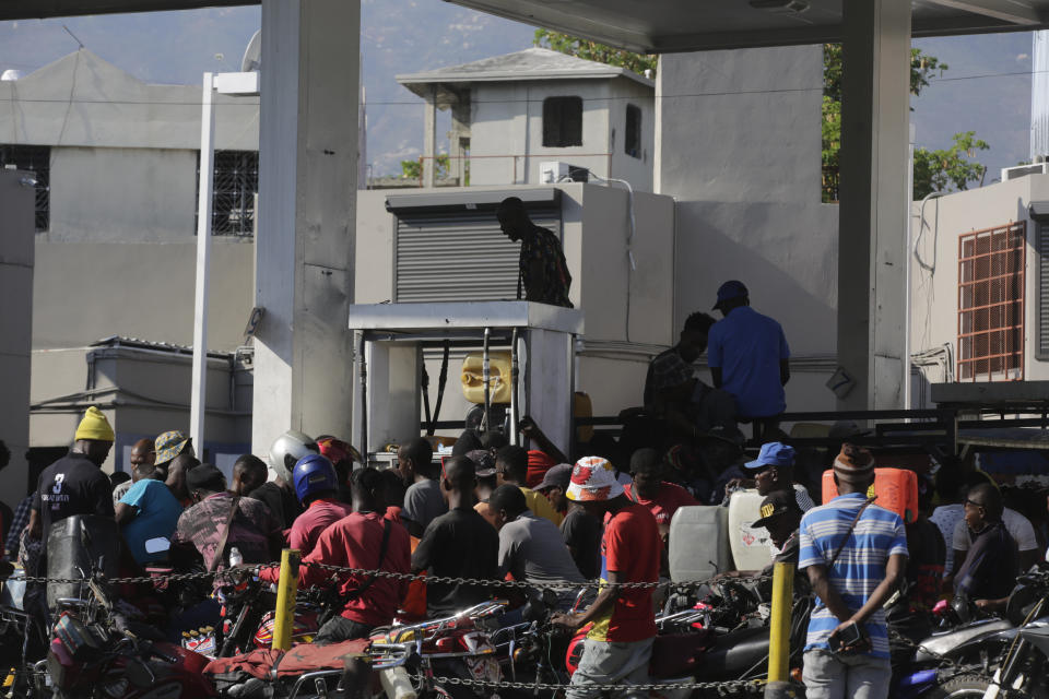 FILE - People crowd around a fuel pump at a gas station in Port-au-Prince, Haiti, April 6, 2024. (AP Photo/Odelyn Joseph, File)