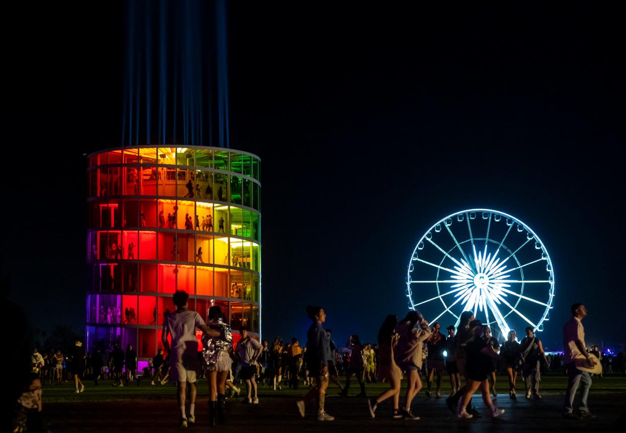 Festivalgoers walk between venues during the Coachella Valley Music and Arts Festival in Indio on Friday, April 12, 2024.