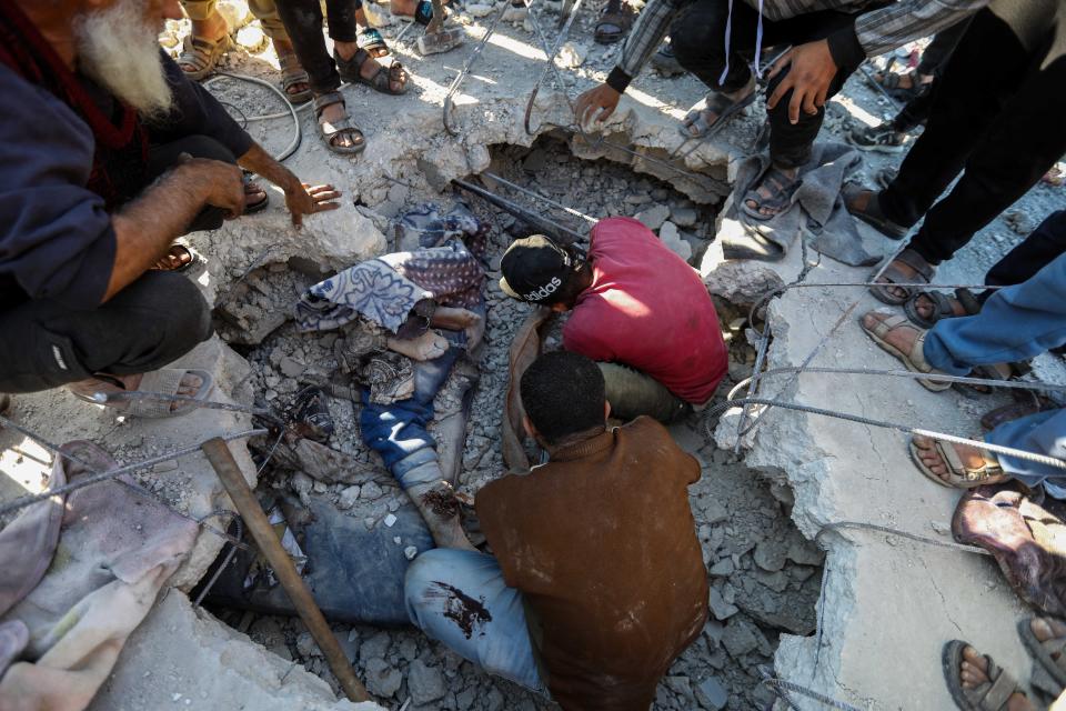 People search for victims in a building that was destroyed during Israeli airstrikes on January 07, 2024 in Rafah, Gaza.