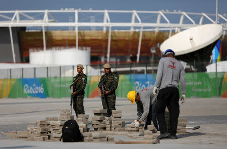 Brazilian Army soldiers patrol in front of the Olympic park ahead of the 2016 Rio Olympics in Rio de Janeiro, Brazil. REUTERS/Bruno Kelly