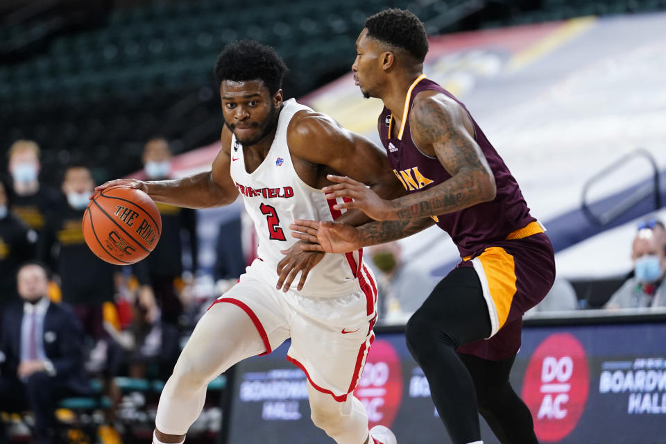 Fairfield's Taj Benning, left, dribbles past Iona's Berrick JeanLouis in the second half of an NCAA college basketball game during the finals of the Metro Atlantic Athletic Conference tournament, Saturday, March 13, 2021, in Atlantic City, N.J. (AP Photo/Matt Slocum)