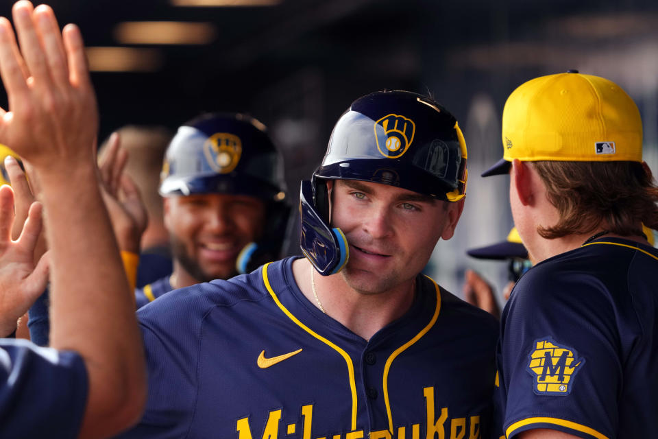 Feb 24, 2024; Peoria, Arizona, USA; Milwaukee Brewers first baseman Tyler Black (86) high fives teammates after scoring a run against the San Diego Padres during the first inning of a Spring Training game at Peoria Sports Complex. Mandatory Credit: Joe Camporeale-USA TODAY Sports