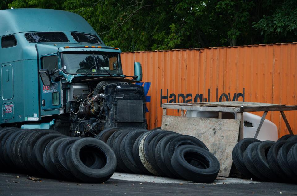 A semi-truck sits alongside used tires, oil and other vehicle parts at a truck parking lot on Elmwood Court in Beech Grove.
