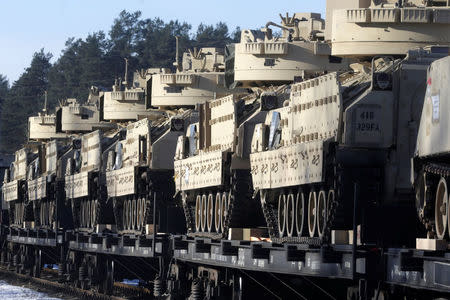 U.S. Bradley fighting vehicles that will be deployed in Latvia for NATO's Operation Atlantic Resolve wait for an unload in Garkalne, Latvia February 8, 2017. REUTERS/Ints Kalnins