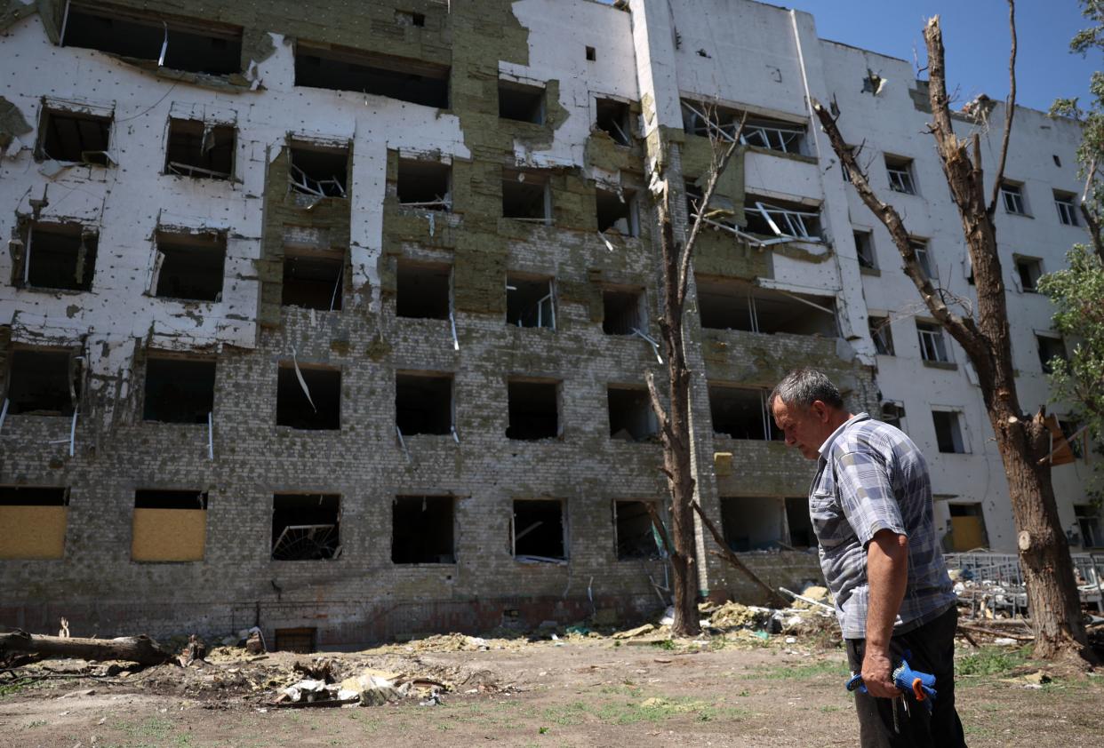 A local resident walks past the destroyed city hospital of Hulyaypole, Zaporizhzhia Region (AFP via Getty Images)