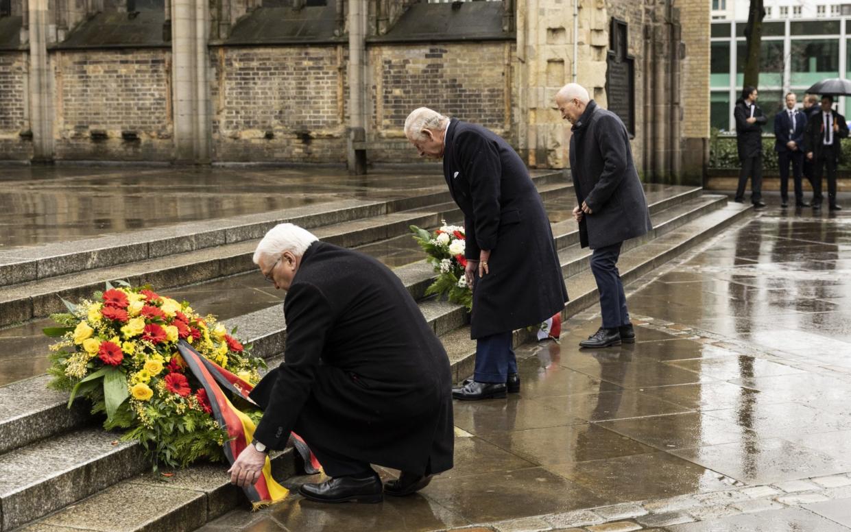 (L-R) German president Frank-Walter Steinmeier, King Charles and the mayor of Hamburg Dr Peter Tschentscher place wreaths on the steps of St Nikolai Memorial Church - Maja Hitij/Getty Images Europe