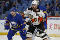 Buffalo Sabres defenseman Will Butcher (4) and Anaheim Ducks center Derek Grant (38) battle for position during the second period of an NHL hockey game, Tuesday, Dec. 7, 2021, in Buffalo, N.Y. (AP Photo/Jeffrey T. Barnes)