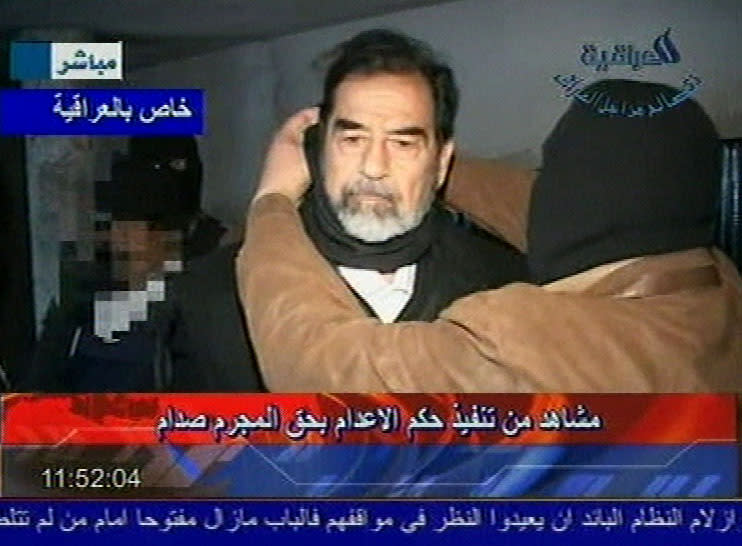 This video image released by Iraqi state television shows Saddam Hussein's guard wearing a ski mask and wrapping a piece of black cloth around the deposed leader's neck moments before his execution Saturday Dec. 30. 2006. Clutching a Quran and refusing a hood, Saddam Hussein went to the gallows before sunrise Saturday, executed by vengeful countrymen after a quarter-century of remorseless brutality that killed countless thousands and led Iraq into disastrous wars against the United States and Iran. (AP Photo/IRAQI TV, HO)