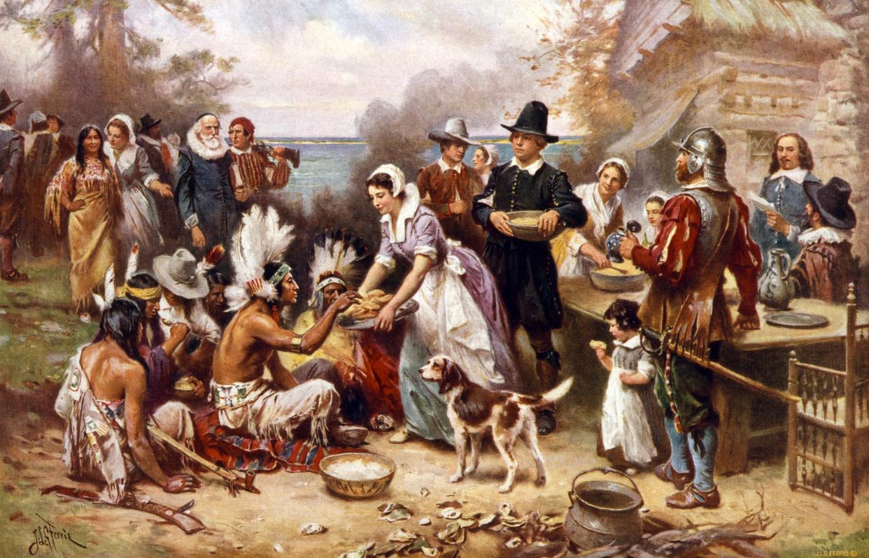 painting of Pilgrims and Native Americans sharing meal in 1621