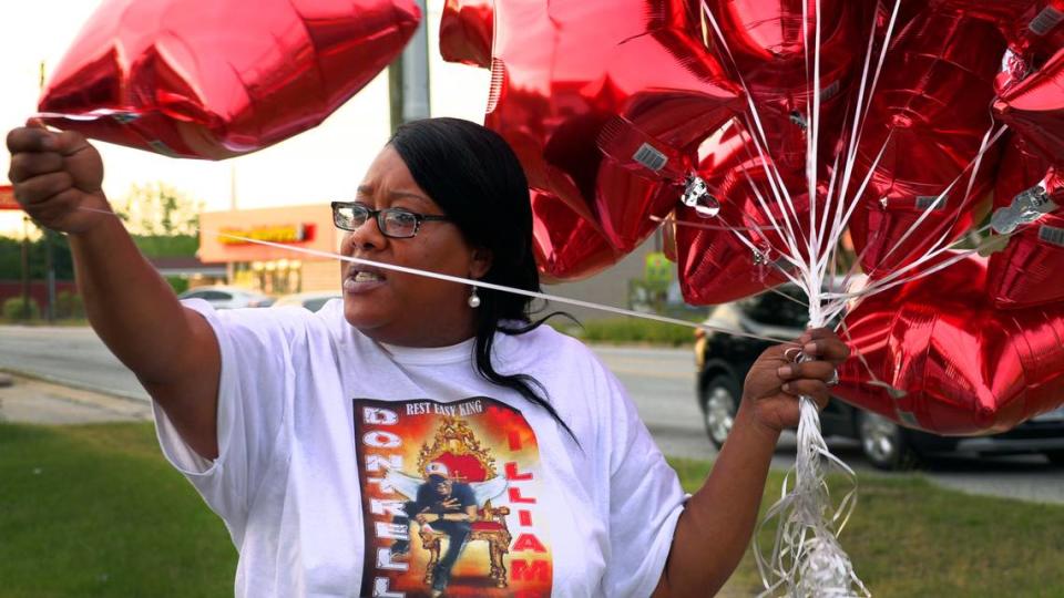 Tanya Weaver, the mother of Dontrell Williams, hands out balloons to those gathered April 27, 2021 at the Circle K convenience store at 5448 Forrest Rd. in Columbus, Georgia to remember what would have been Williams’ 28th birthday. Dontrell Williams was shot and killed in 2019 while working an overnight shift at this same store. Mike Haskey/mhaskey@ledger-enquirer.com