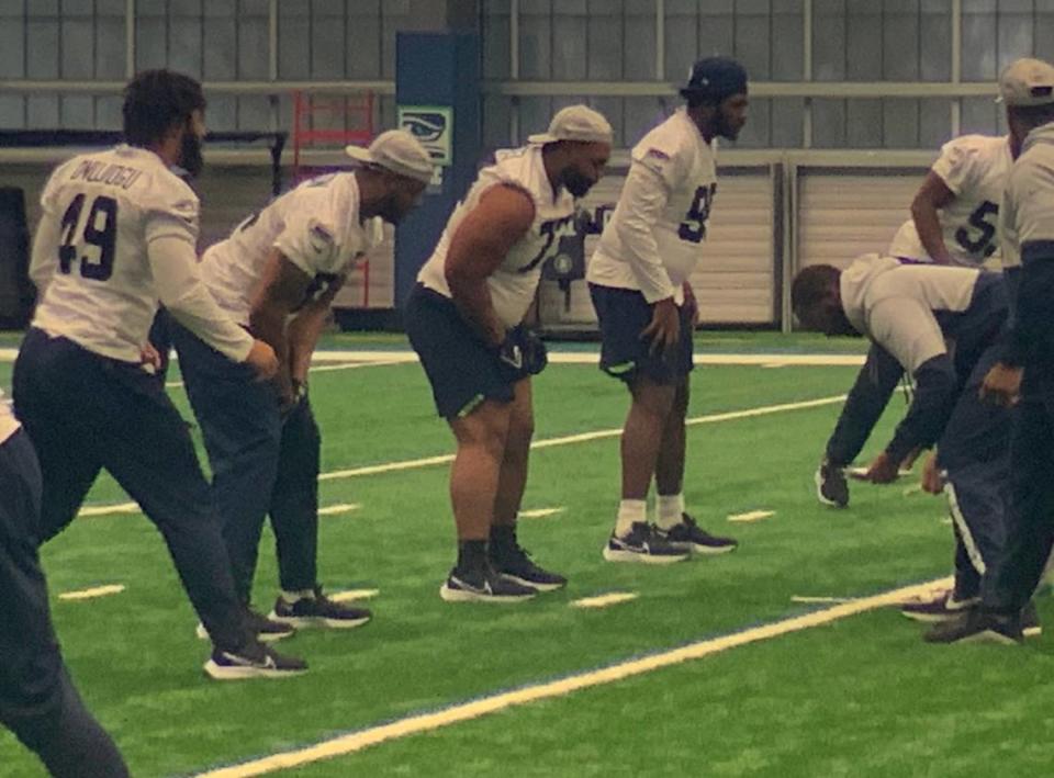 Matt Gotel from Tacoma and Lakes High School (third from left, sleeves pushed up) lines up with fellow defensive linemen during a walk-through practice on the final day of Seahawks rookie minicamp May 8, 2022, at the team’s Virginia Mason Athletic Center in Renton.