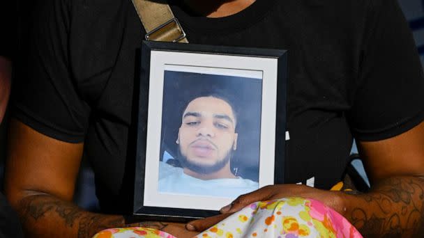 PHOTO: The girlfriend of Donovan Lewis holds a picture of him during a rally at the Columbus Division of Police Headquarters, Sept. 2, 2022, in Columbus, Ohio. (Gaelen Morse/Getty Images)