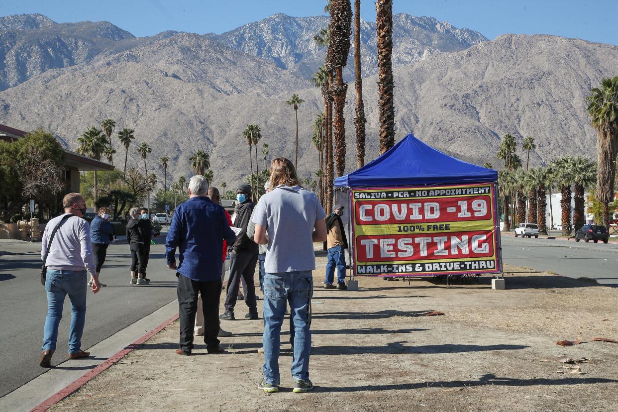People stand in line at a pop-up COVID-19 testing tent in Palm Springs, January 5, 2022.