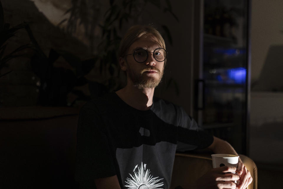 Oleksandr Solovei, 25, the owner of the coffee shop Informatyka, poses for the portrait during a blackout in Kyiv, Ukraine, Friday, June 7, 2024. Solovei plans to buy a generator, which typically costs around $1,000, to keep his business open during blackouts. (AP Photo/Alex Babenko)