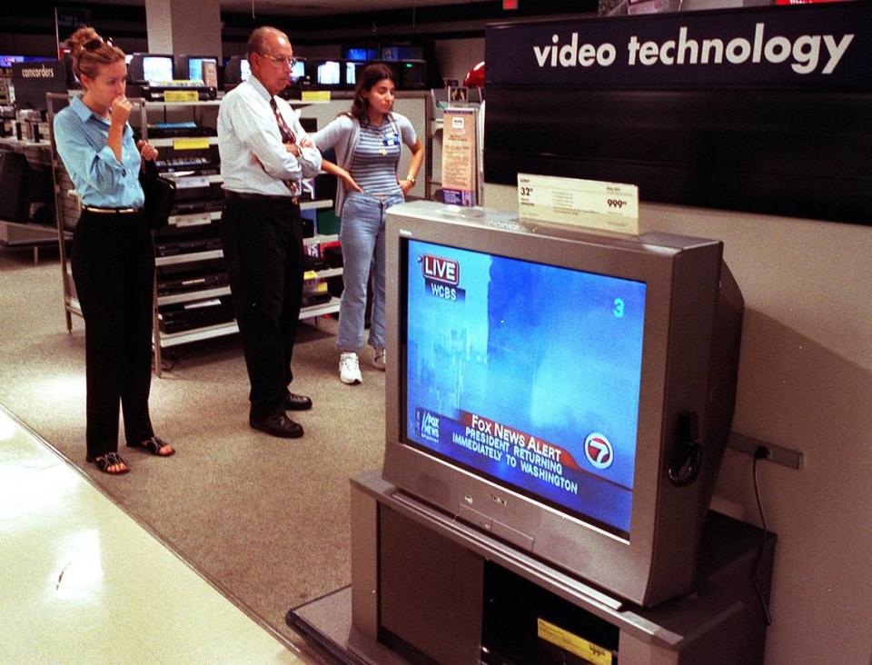 Sears employees and customers watch coverage of the 9/11 terror attacks in 2001.