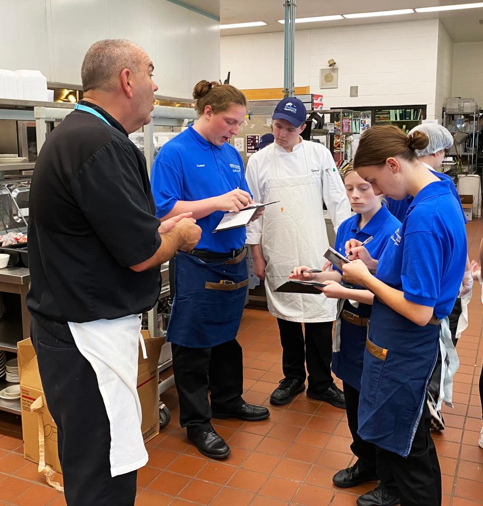Bristol-Plymouth Regional Technical School culinary arts chef and instructor Scott Cowell leads a pre-service review of the day's specials with student servers at the Silver Platter restaurant on Oct. 6, 2022.