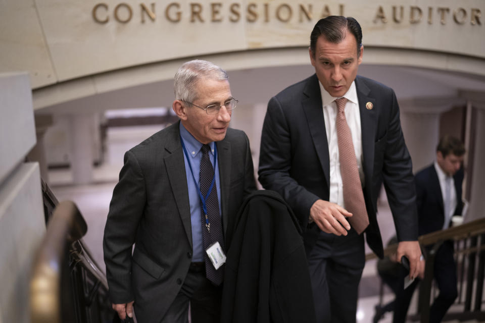 Dr. Anthony Fauci, left, director of the National Institute of Allergy and Infectious Diseases, speaks with Rep. Tom Suozzi, D-N.Y., right, after updating members of Congress on the coronavirus outbreak, on Capitol Hill in Washington, Thursday, March 12, 2020. (AP Photo/J. Scott Applewhite)