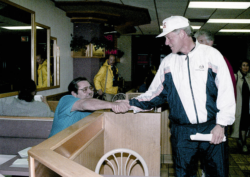 Washington, DC. 11-19-1992 President-Elect William Jefferson Clinton goes jogging and stops at the McDonald's location on Mst. Nw. in Washington DC. Mr. Clinton stops and shakes hands with people who were sitting and eating at the McDonalds. Credit: Mark Reinstein (Photo by Mark Reinstein/Corbis via Getty Images)