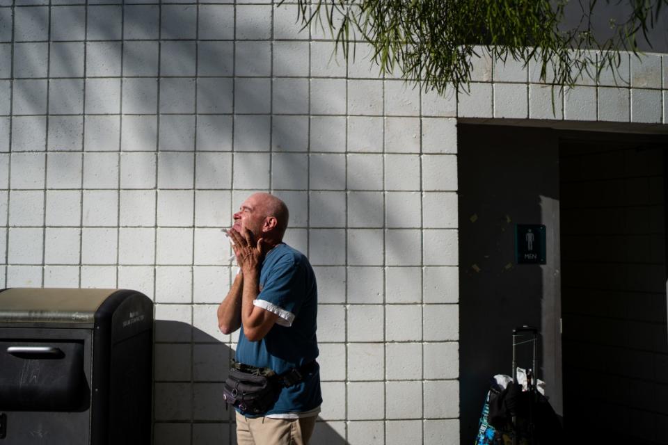 Terrance Whitten, 67, dries his face after washing in the public restroom at the Pan Pacific Park on Friday.