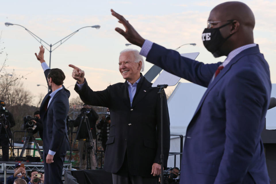 Joe Biden at a rally with democratic candidates Jon Ossoff (L) and Raphael Warnock (R).