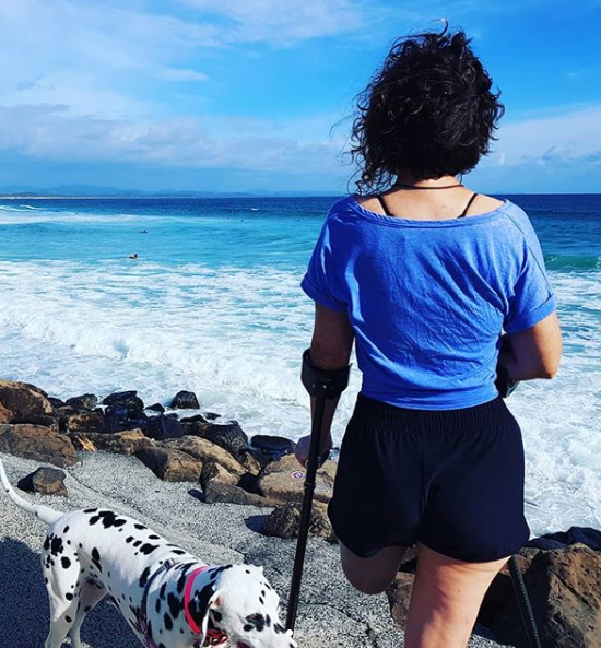 Ms Carden said the amputation has given her her life back. She now enjoys walks with her dog on the beach every day (pictured). Source: Anita Carden