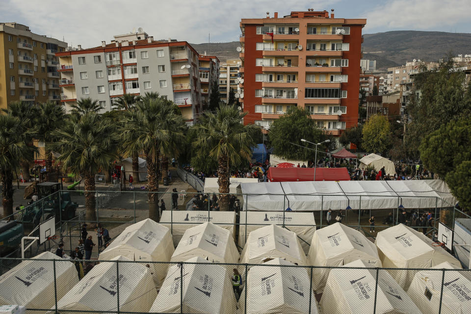Tents set up for homeless people are placed on a basketball court in Izmir, Turkey, Monday, Nov. 2, 2020. Rescue teams continue ploughing through concrete blocs and debris of collapsed buildings in Turkey's third largest city in search of survivors of a powerful earthquake that struck Turkey's Aegean coast and north of the Greek island of Samos, Friday Oct. 30, killing dozens. Close to a thousand people were injured.(AP Photo/Emrah Gurel)
