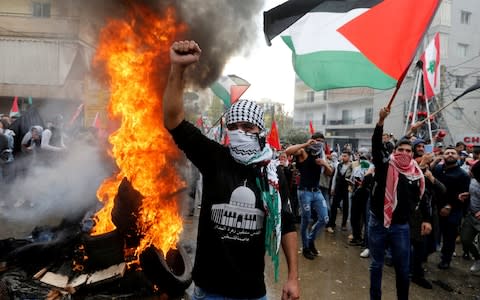 Protesters are seen near the U.S. embassy in Awkar, in Beirut - Credit: REUTERS/Mohamed Azakir