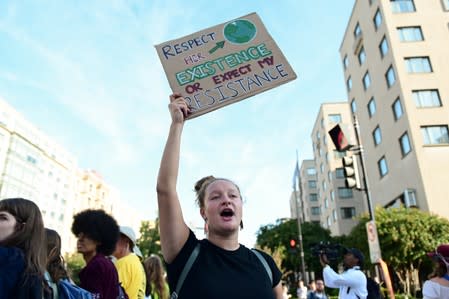 Climate change activists block traffic at an intersection near the White House in Washington