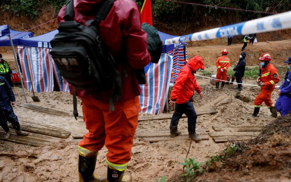 Rescue workers at the site where the China Eastern Airlines Boeing 737-800 plane crashed in March - Reuters