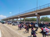 Migrants shelter under the Del Rio International Bridge which connects with Mexico