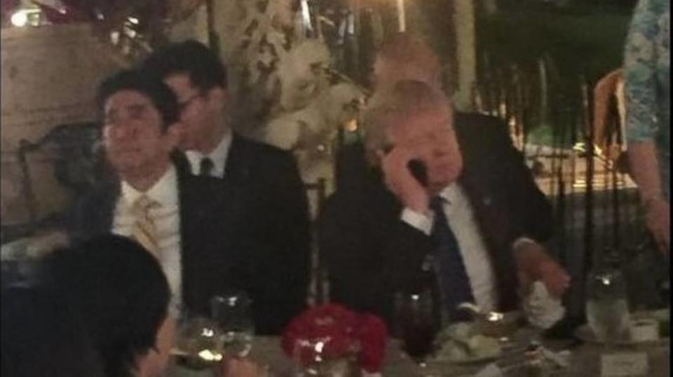 Donald Trump is shown at dinner at Mar-a-Lago with Japanese Prime Minister Shinzo Abe after receiving news of a North Korean missile test. A club member snapped the photo and posted it to Facebook.