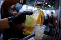 Bartenders serve cannabis-mixed sparkling craft soda during the "360 Cannabis & Hemp for the People" expo in Buriram province