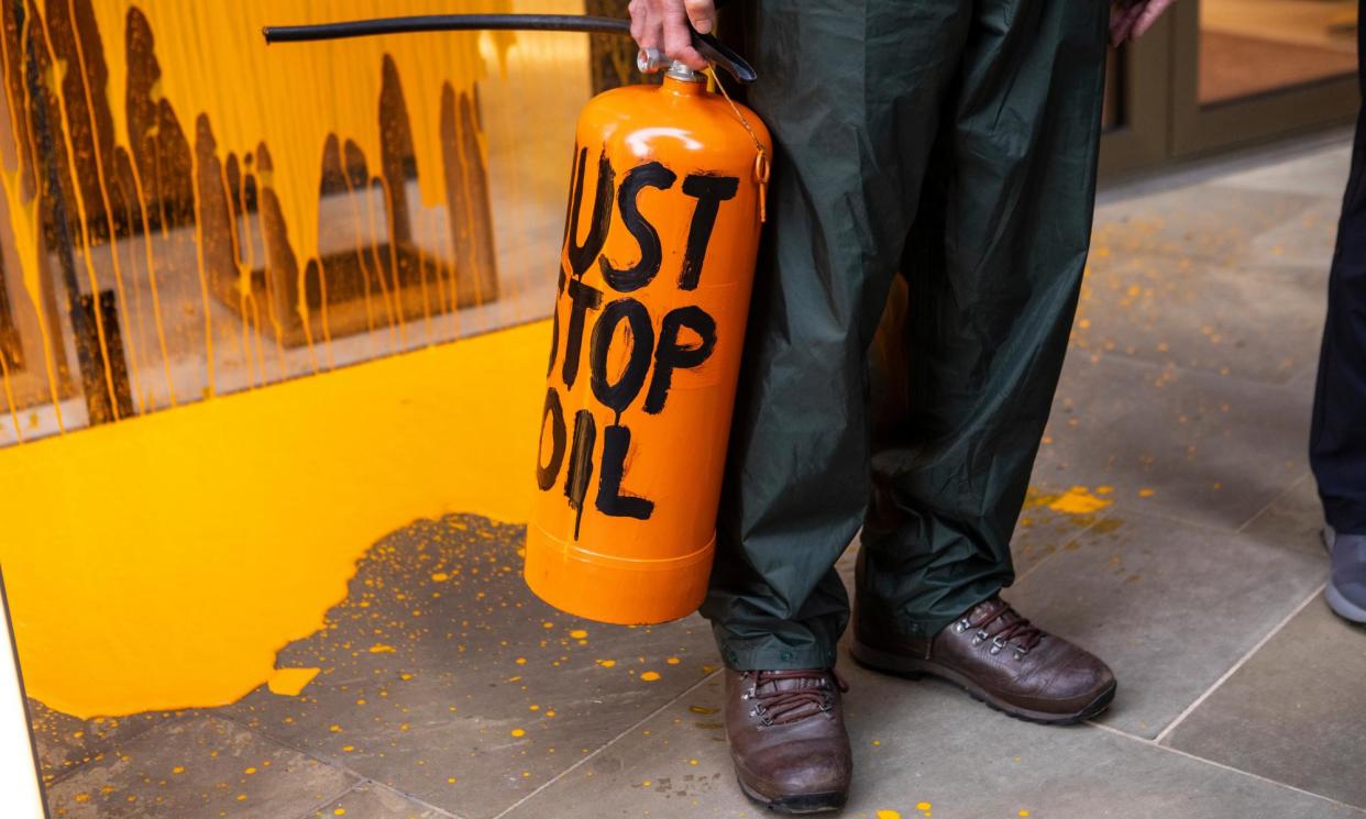 <span>Just Stop Oil activists use orange spray paint during a protest in central London as part of the campaign to highlight climate change.</span><span>Photograph: Antonio Olmos/The Observer</span>