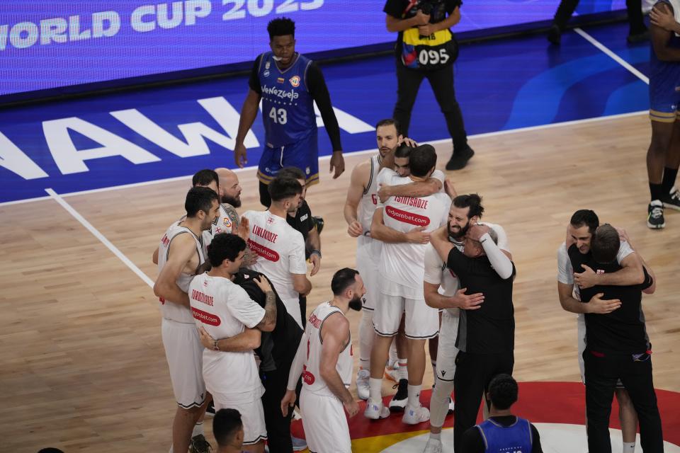 Georgia team members celebrate after defeating Venezuela in their Basketball World Cup group F match in Okinawa, southern Japan, Wednesday, Aug. 30, 2023. (AP Photo/Hiro Komae)