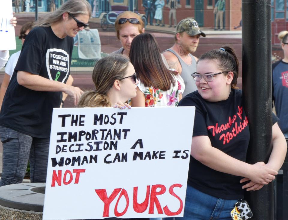 Logan Wilson, left, and Olivia Stevenson, both 20, drove from Erie, Michigan, to participate in the protest Monday in Bucyrus.