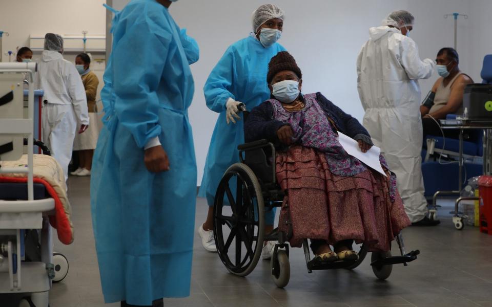 A woman arrives at a hospital in Bolivia to receive a dose of a coronavirus vaccine through the Covax scheme - Martin Alipaz/EPA-EFE/Shutterstock