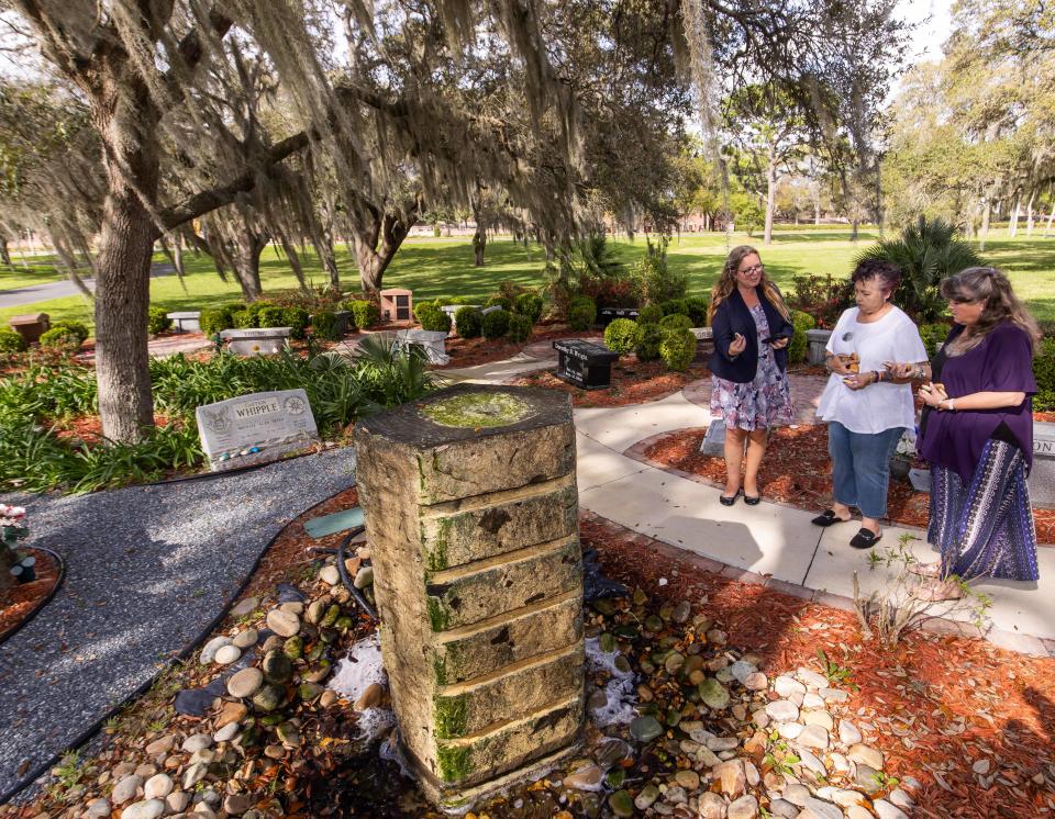 Rachael Reimer with Good Shepherd Memorial Garden, left, directs Michelle Pepin, center, and Lisa Bolton, right, where to place rocks around a fountain in the Walk of Memories in the Cremation Garden at the Good Shepherd Memorial Gardens on Wednesday.