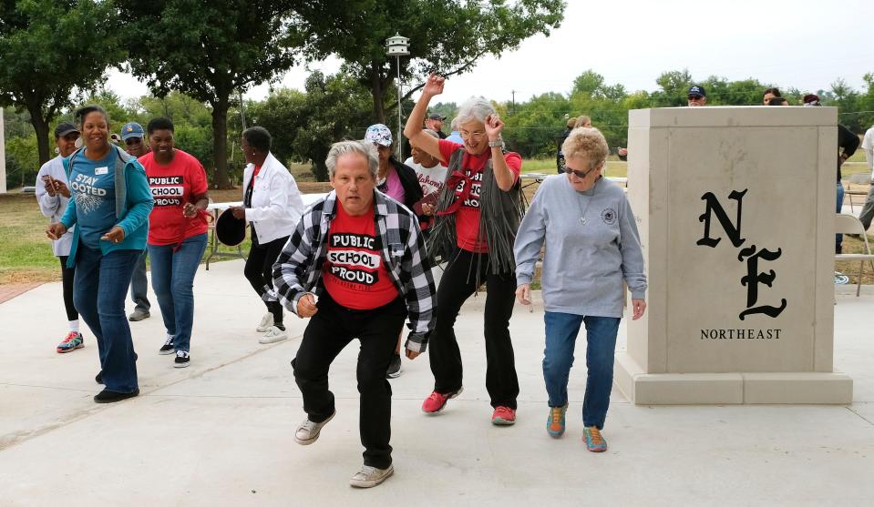 A group of Northeast alumni dance next to the monument. During the Northeast High School Legacy Plaza dedication and reenactment of a civil rights march the students did to the Capitol in 1970. Monday, October 7, 2022