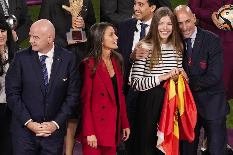 President of Spain's soccer federation, Luis Rubiales, right, embrace's Spain's Princess Infanta Sofia as Queen Letizia and FIFA President Gianni Infantino wait on the podium following Spain's win in the final of Women's World Cup soccer against England at Stadium Australia in Sydney, Australia, Sunday, Aug. 20, 2023. (AP Photo/Mark Baker)